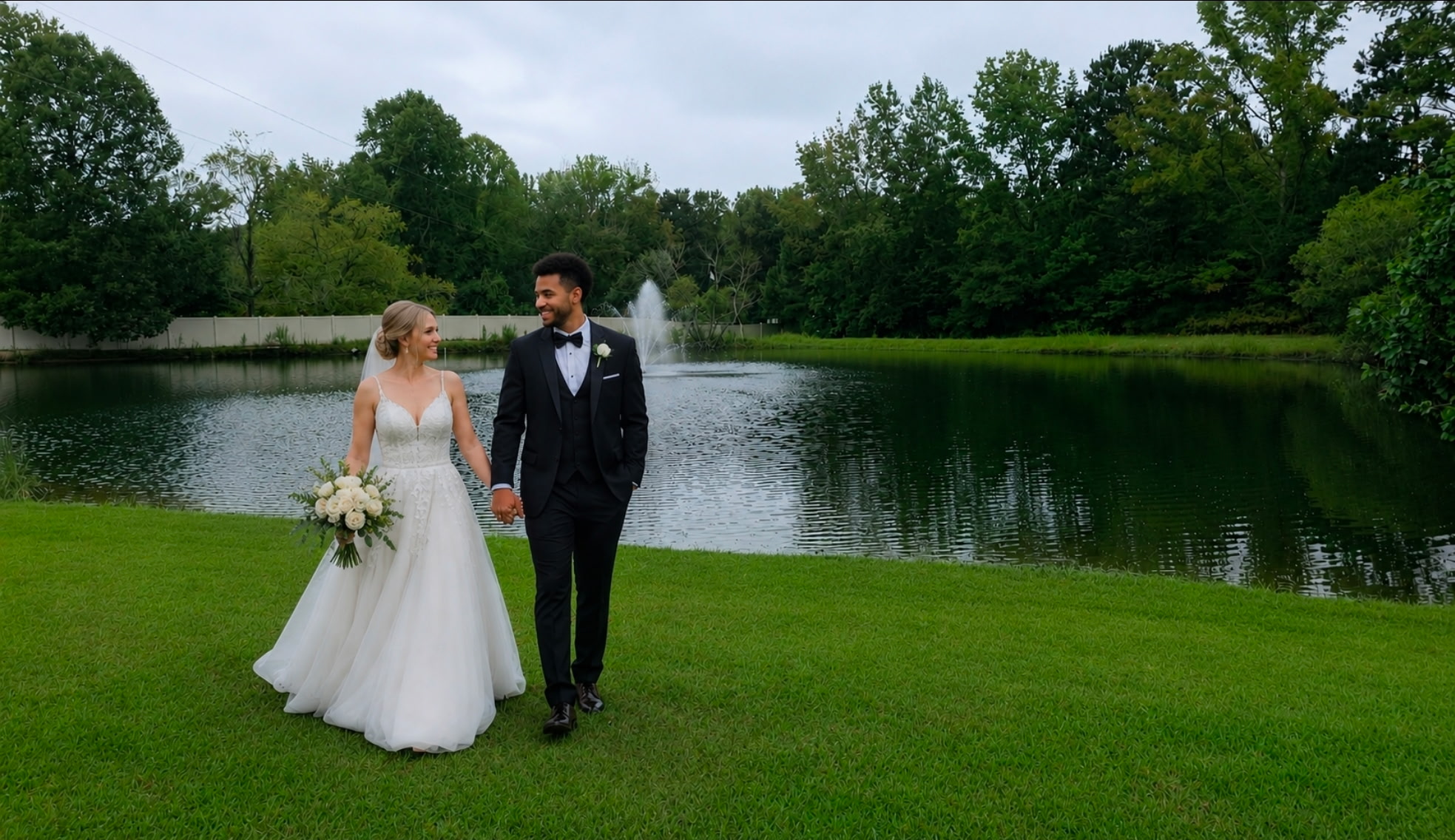 Bride and groom by the pond